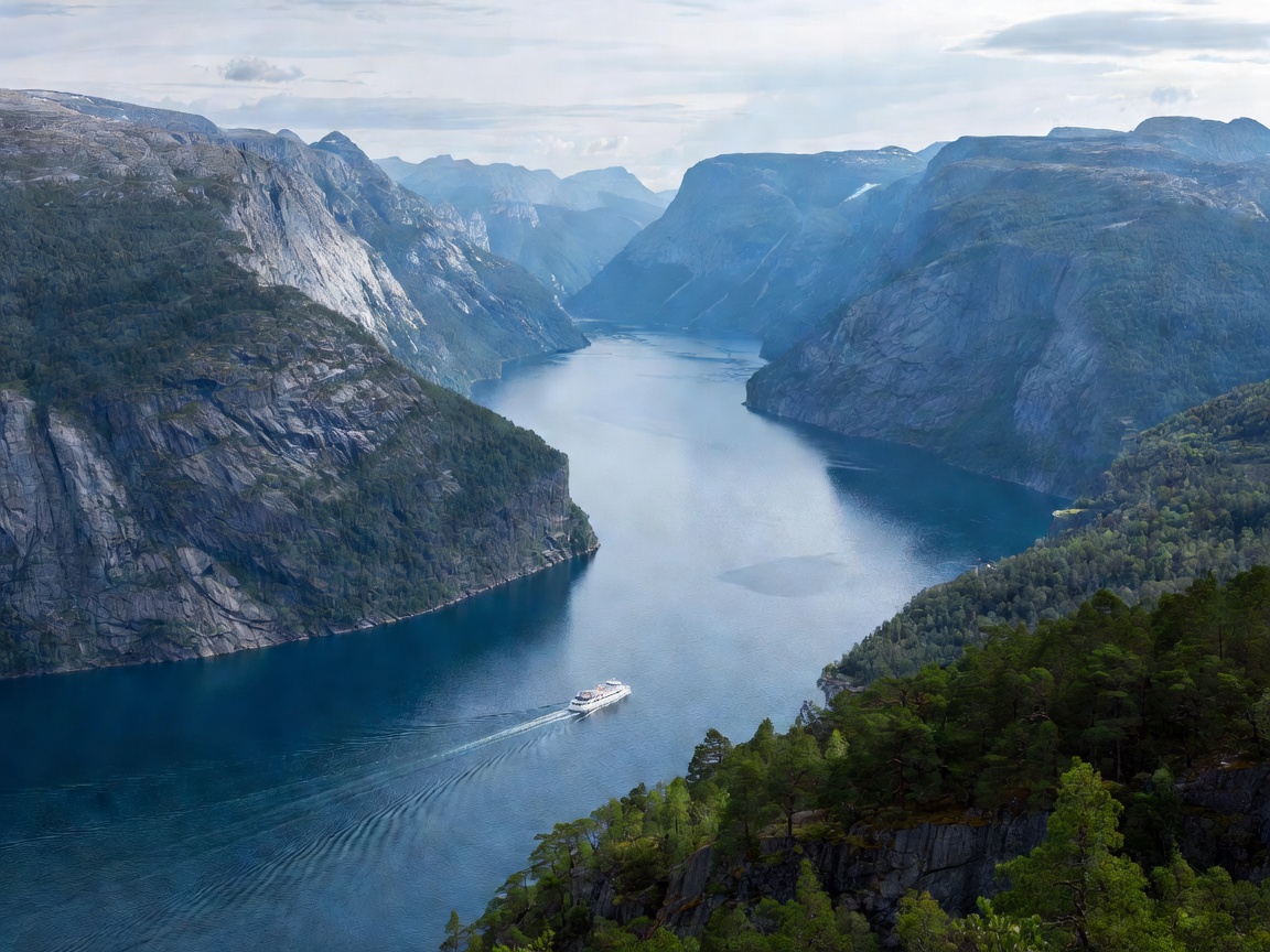 Deep blue Norwegian fjord surrounded by steep lush mountains in Geiranger Norway